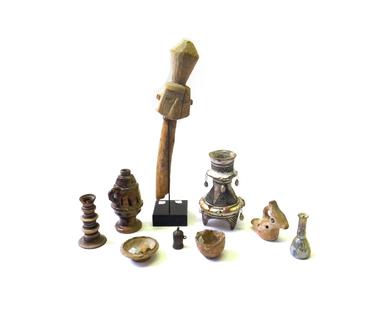 Appraisal: A group of antiquities comprising a terracotta candlestick cm high