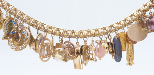 Appraisal: Gold charm bracelet with a k triple link chain which