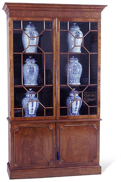 Appraisal: A George III style mahogany bookcase Enclosed by a pair