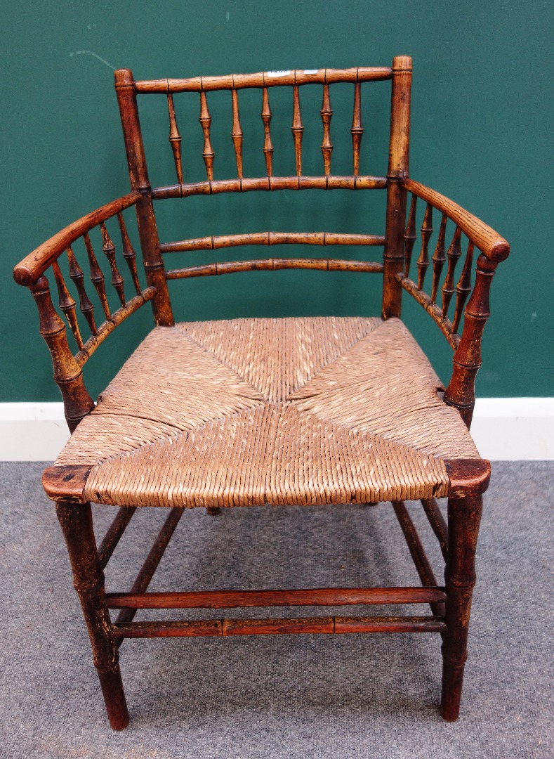 Appraisal: A provincial ash and faux bamboo turned rush seated armchair