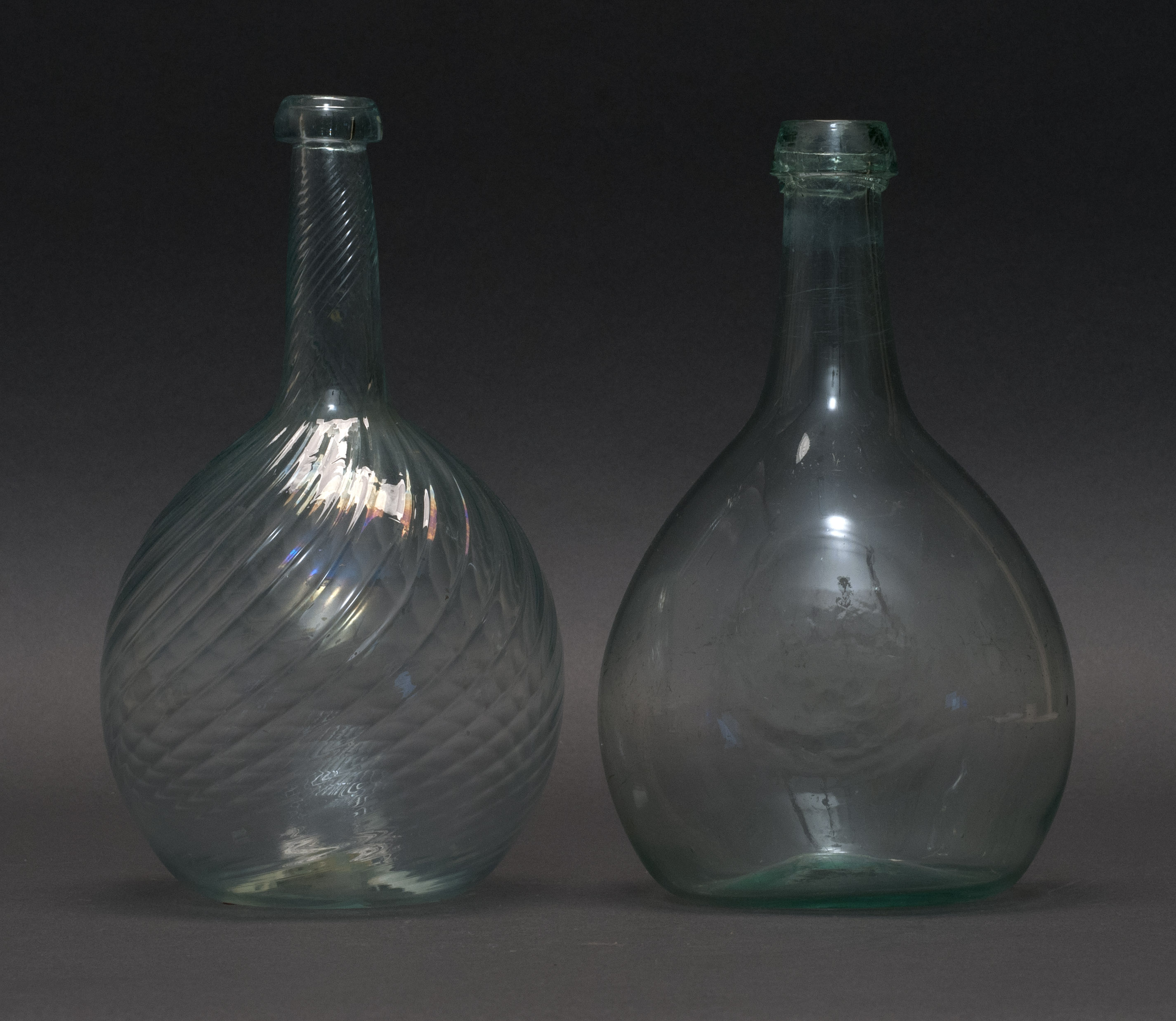 Appraisal: TWO FREE-BLOWN GLASS BOTTLES th CenturyWith applied collars Rough pontil