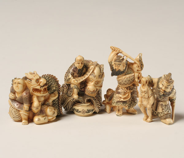 Appraisal: Japanese carved ivory netsukes men with beasts Some ivory Tallest