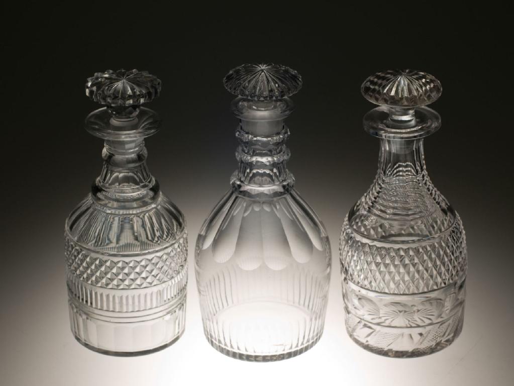 Appraisal: GROUP OF THREE th CENTURY CUT-GLASS DECANTERS each of mallet