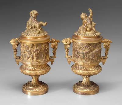 Appraisal: Pair bronze dore lidded urns finials with putti one with