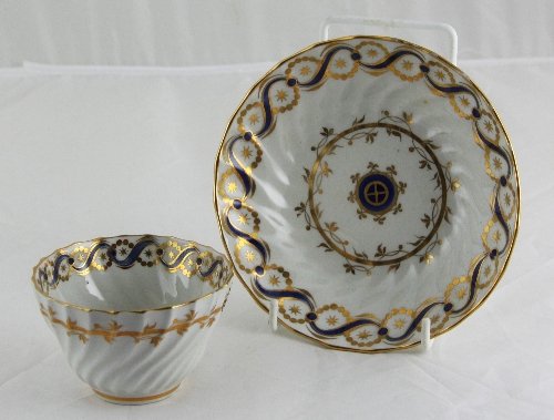 Appraisal: A spirally ribbed tea bowl and saucer possibly New Hall