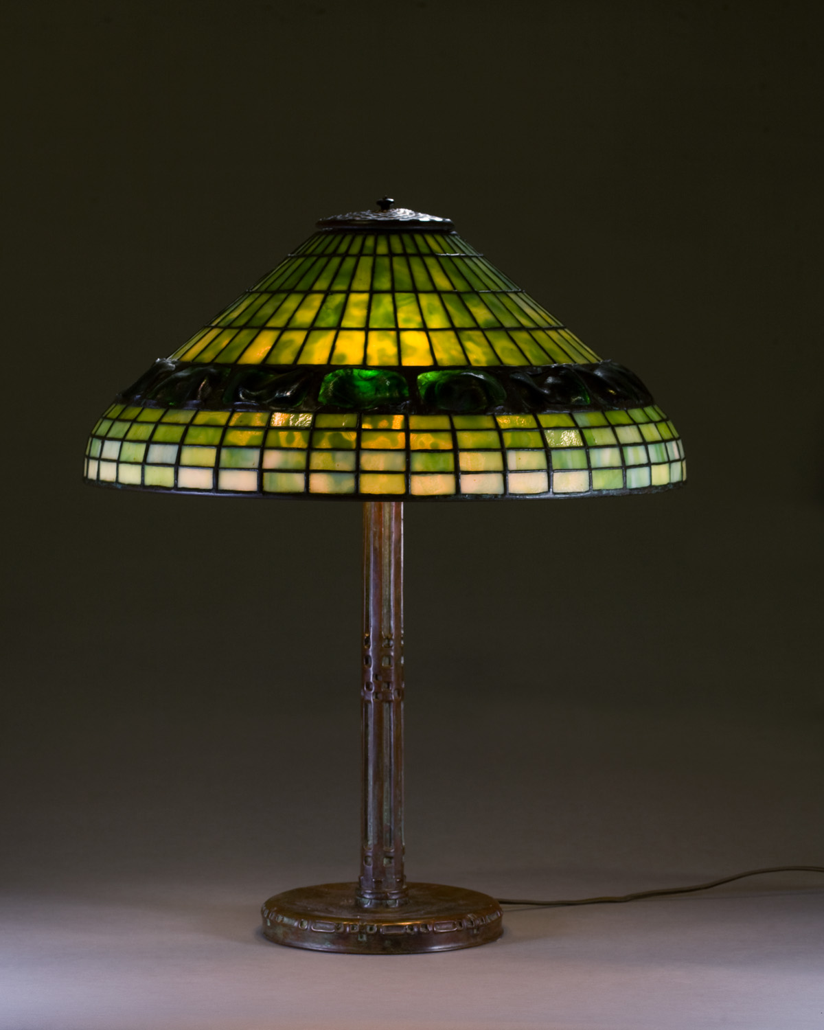 Appraisal: TIFFANY STYLE LAMP WITH TURTLEBACK SHADE AND BRONZE BASE Height