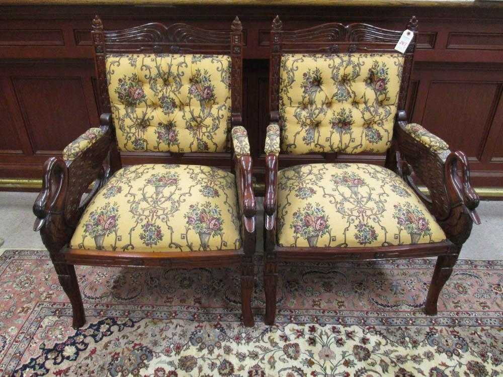 Appraisal: A PAIR OF CARVED AND UPHOLSTERED MAHOGANY ARMCHAIRS Empire style