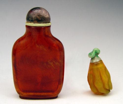 Appraisal: CARVED SNUFF BOTTLES Buddha finger carved in amber or stone