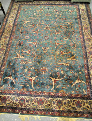 Appraisal: An Indo-Persian Kirman carpet emerald green ground cm x cm