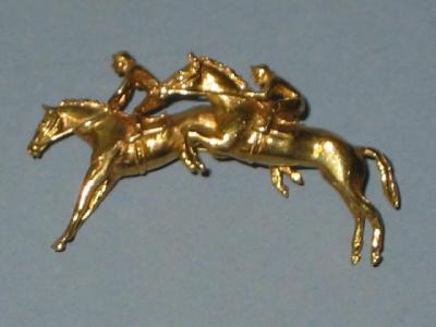 Appraisal: A CT GOLD BROOCH modelled as a pair of race