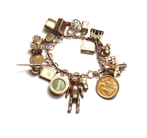 Appraisal: A ct gold circular and bar link charm bracelet on