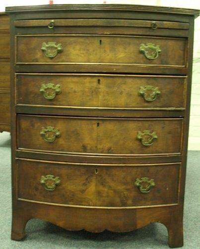 Appraisal: A mahogany bow front chest with brushing slide fitted four