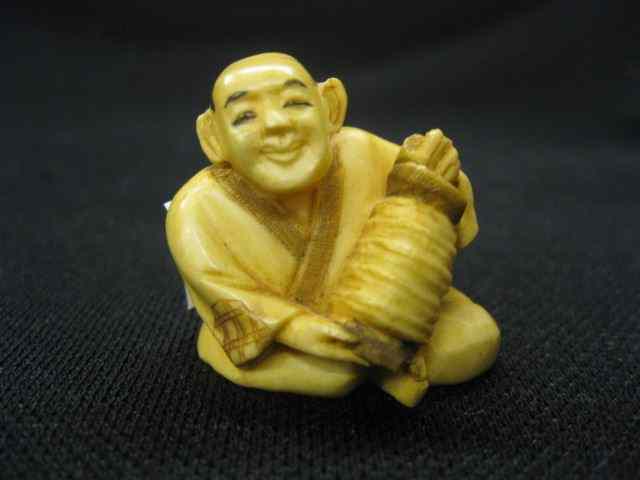 Appraisal: Carved Ivory Netsuke of a Seated man with accordian ''