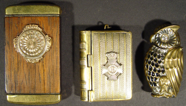 Appraisal: Three vestas one metal book shaped with military crest one