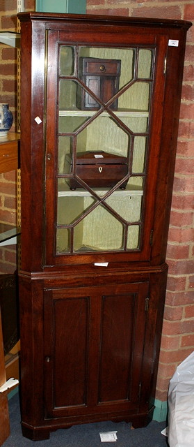 Appraisal: A GEORGE III MAHOGANY FLOOR STANDING CORNER CABINET the upper