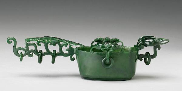 Appraisal: A 'spinach' jade long-handled cup The cup of oval section