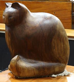 Appraisal: Large carved wood studio figure of a stylized recumbent feline