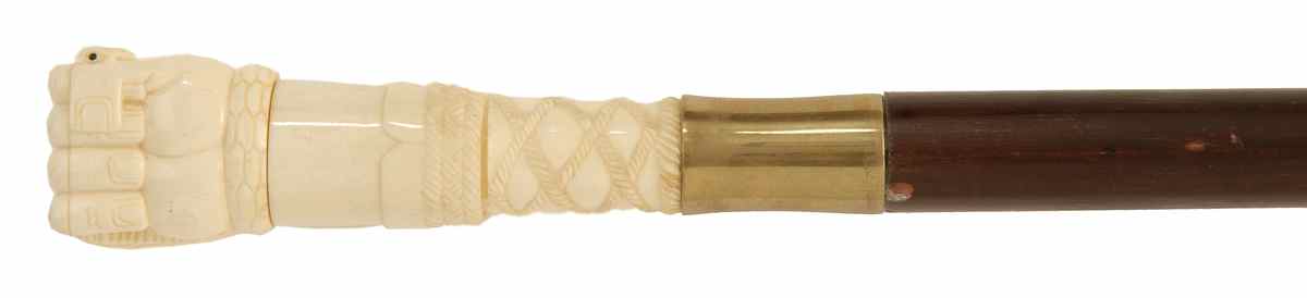 Appraisal: WALRUS IVORY AND WOOD WALKING STICK With ivory fist-form handle