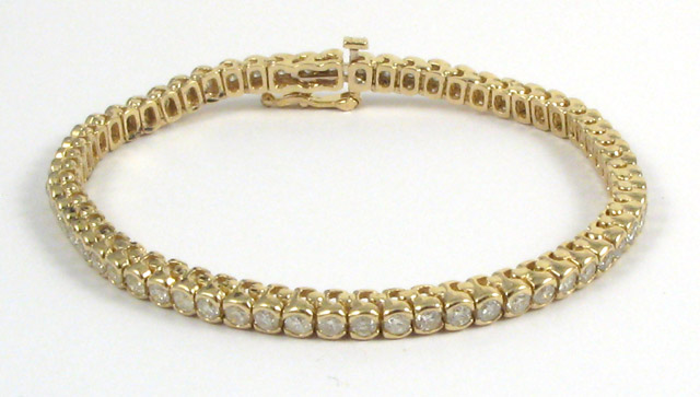 Appraisal: DIAMOND AND FOURTEEN KARAT GOLD BRACELET in length and set