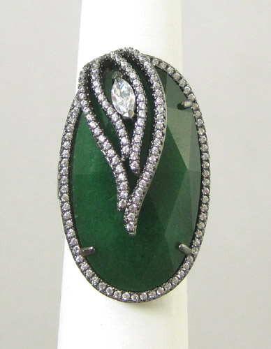 Appraisal: JADE AND STERLING SILVER RING featuring an oval facet-cut green