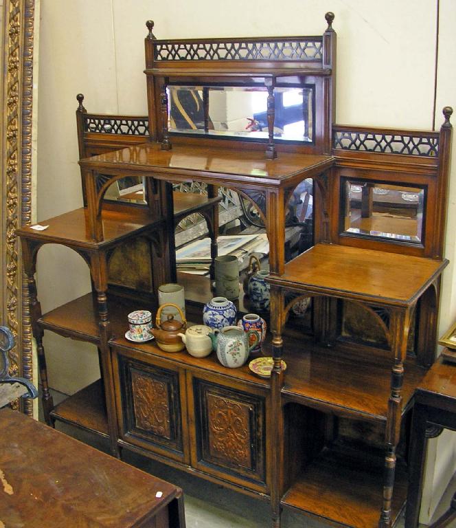 Appraisal: A Victorian walnut aesthetic style side cabinet with mirrored back