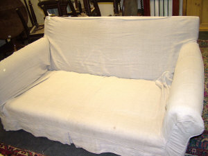 Appraisal: A Modern two seater cream upholstered sofa the square back