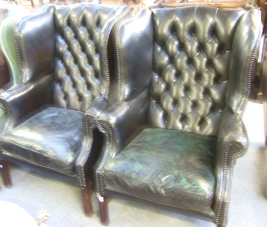 Appraisal: A pair of mid th century style wing back armchairs