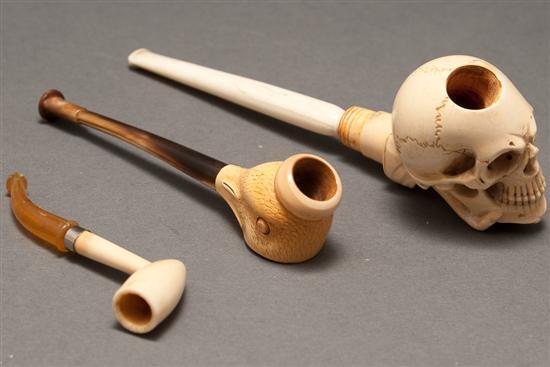 Appraisal: Three Continental carved ivory pipes meerschaum skull in hand form