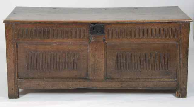 Appraisal: A carved oak chest th Century style with carved stop