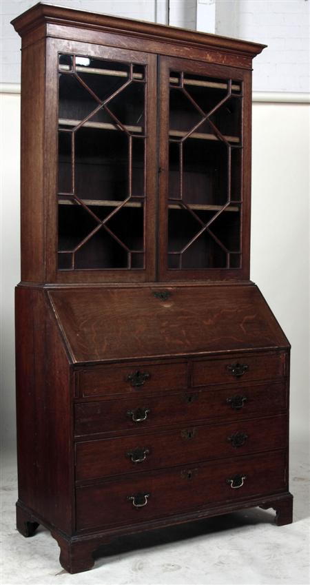 Appraisal: A George III oak bureau bookcase the projected moulded cornice