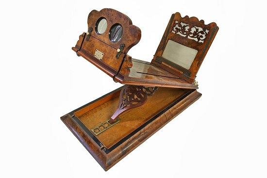 Appraisal: A late th Century figured walnut stereoscope with pierced ratchet