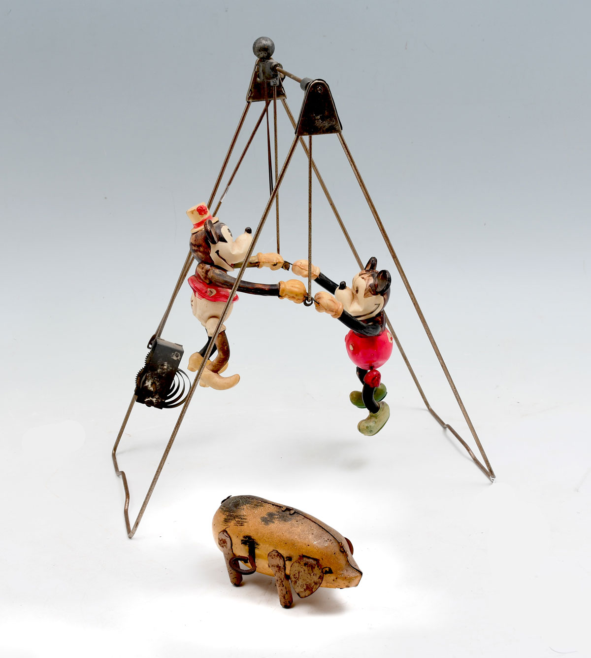 Appraisal: DISNEY'S MICKEY MOUSE SWING AND WIND-UP PIG Celluloid trapeze windup