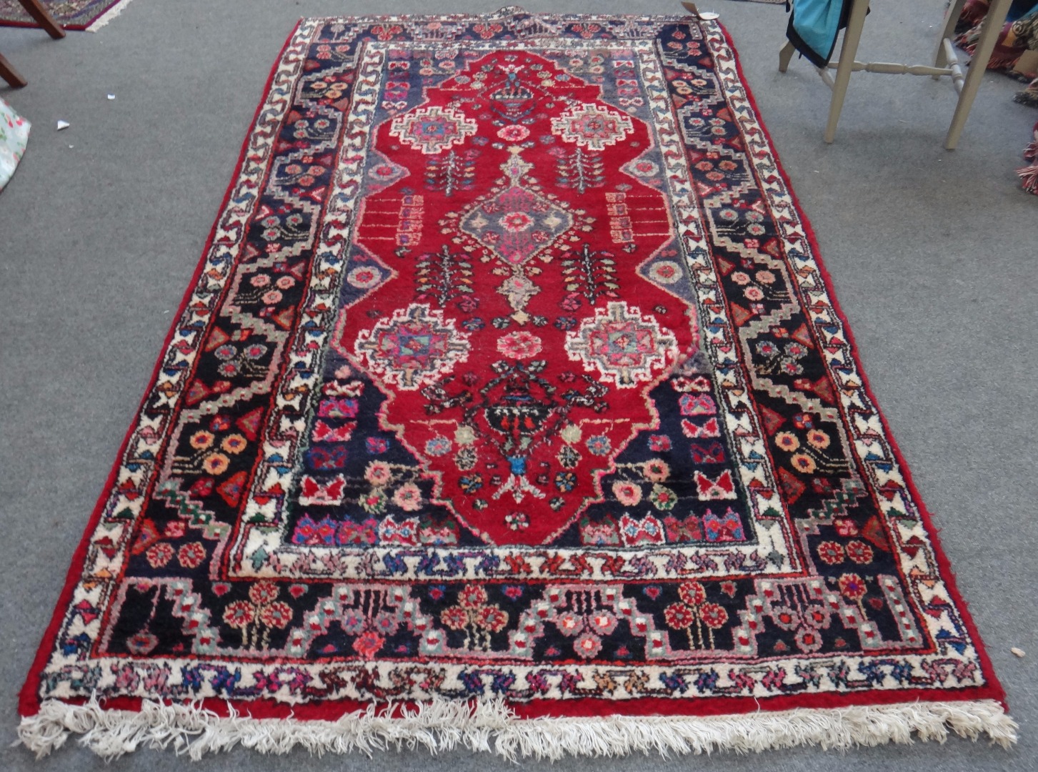 Appraisal: A Hamadan rug Persian the madder field with a central