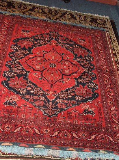 Appraisal: AN EASTERN RED GROUND RUG - decorated a central large