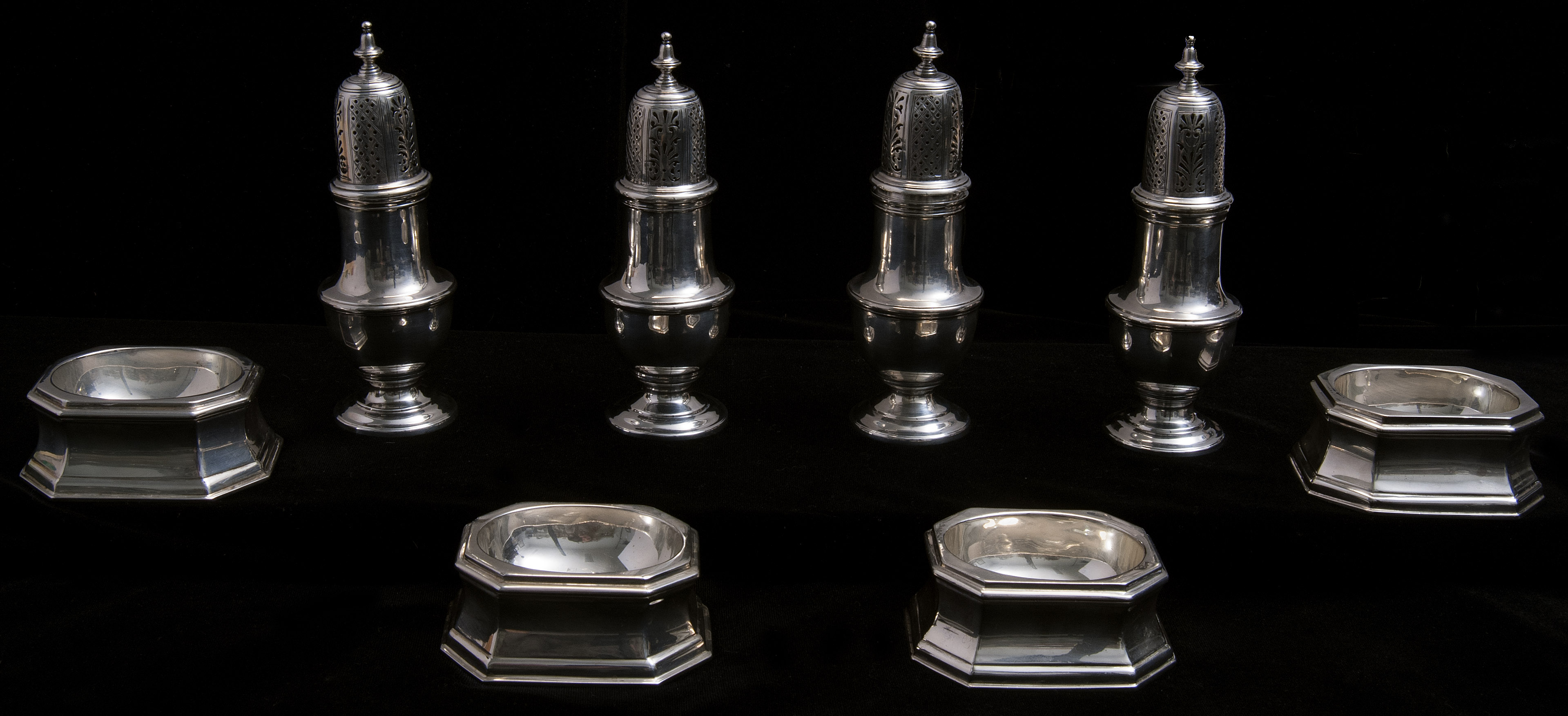 Appraisal: EIGHT ASSEMBLED GEORGE V STERLING SILVER CASTORS AND TRENCHER SALTS