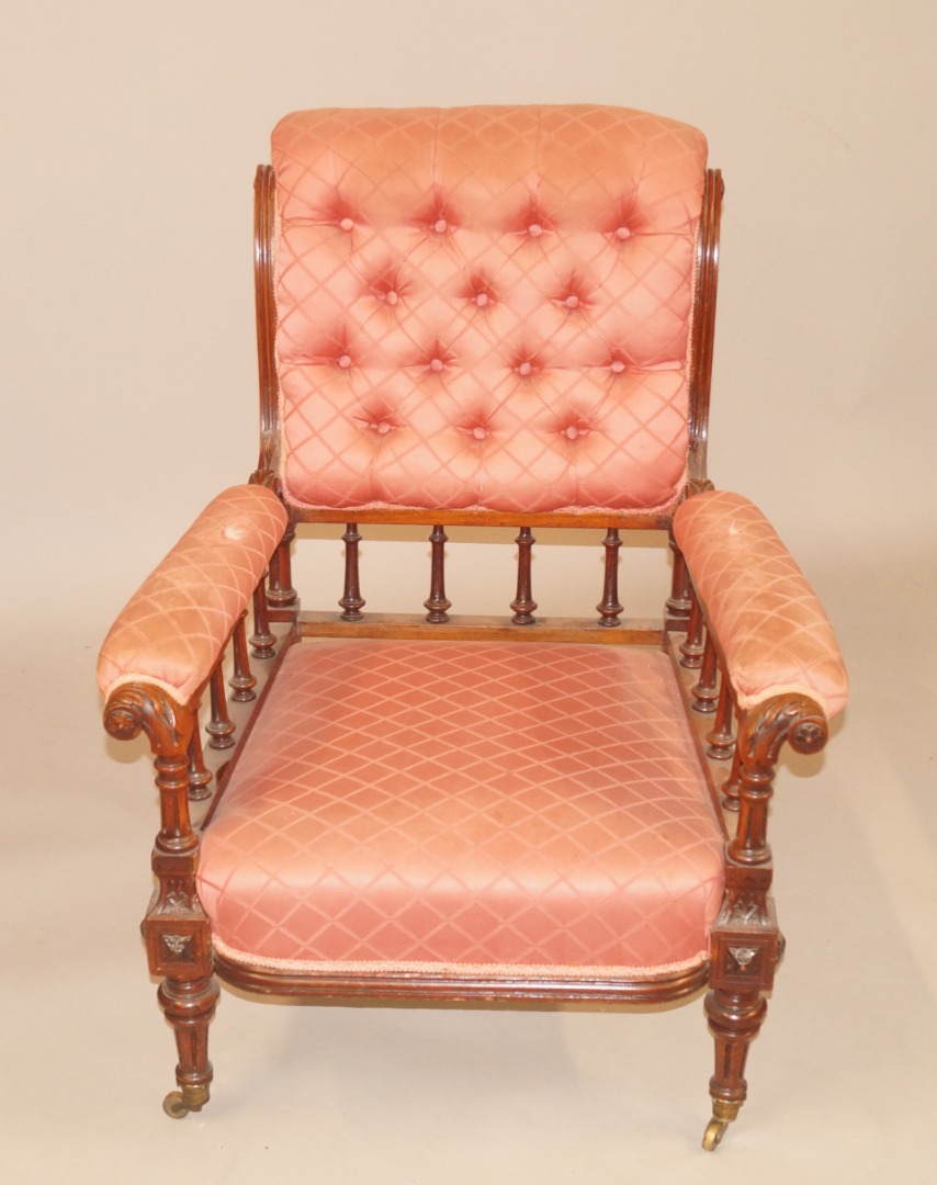 Appraisal: A Victorian walnut open armchair with a buttoned padded back