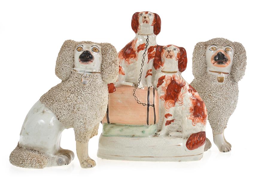 Appraisal: STAFFORSHIRE SPANIEL GROUP AND A PAIR OF POODLE FIGURES ALL