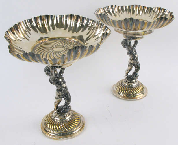 Appraisal: PAIR VICTORIAN STYLE SILVER PLATED COMPOTES with figural putti raised