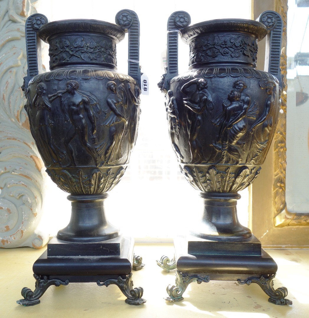 Appraisal: A pair of patinated bronze two handled urns th century