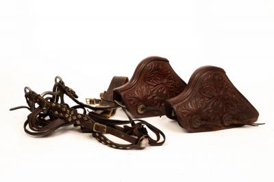 Appraisal: A pair of monkey nosed tapaderos engraved with flower decoration