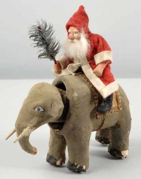 Appraisal: Santa Riding Nodding Elephant with Dresden Saddle Description Santa has