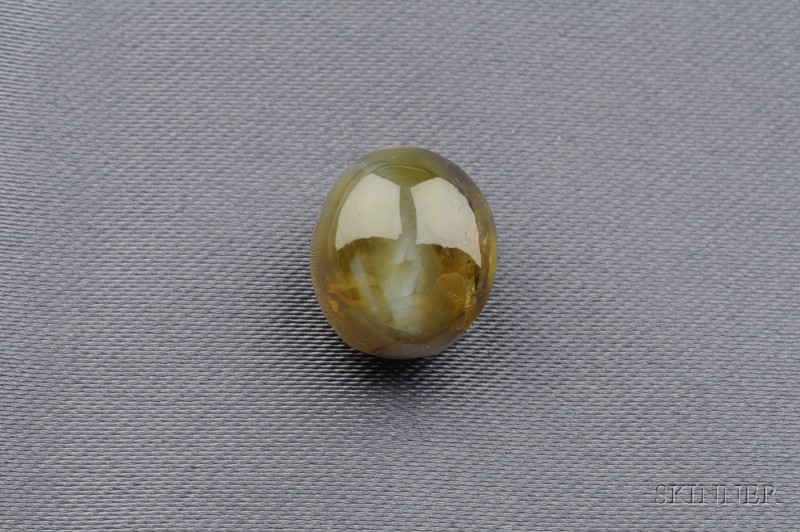 Appraisal: Unmounted Cat's-eye Chrysoberyl the double cabochon weighing cts Underside unpolished