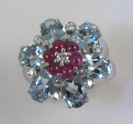 Appraisal: RUBY DIAMOND AND AQUAMARINE RING The k white gold floral