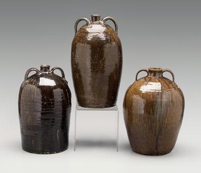 Appraisal: Three alkaline glaze jugs one with two strap handles mottled