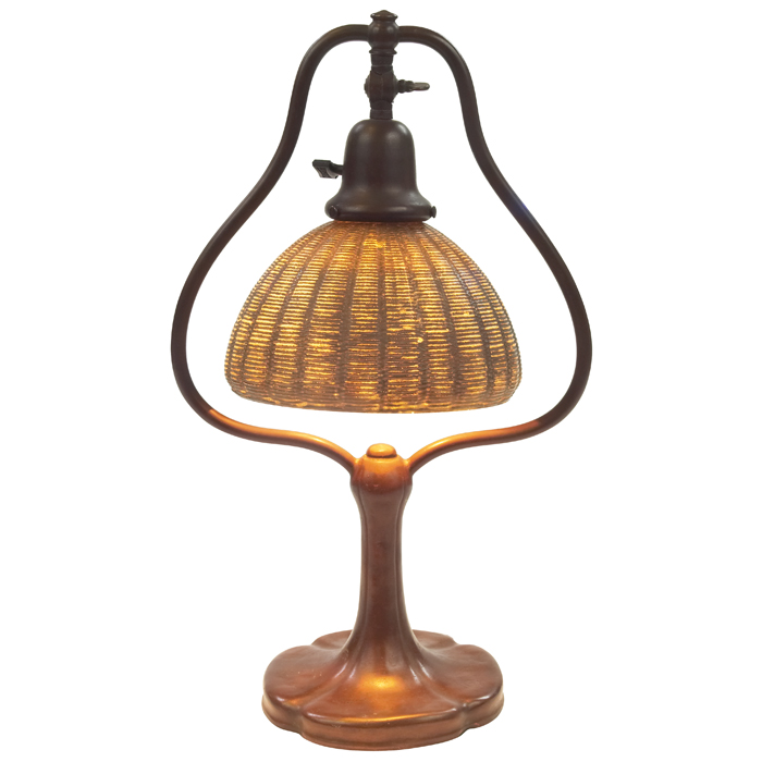 Appraisal: Handel lamp harp base holds a glass shade with basket