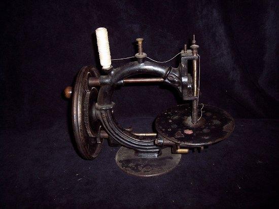 Appraisal: A sewing machine the circular platform with mother-of-pearl type decoration