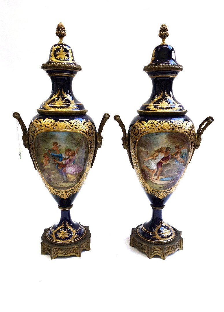 Appraisal: A pair of Sevres style ormolu mounted lidded porcelain vases