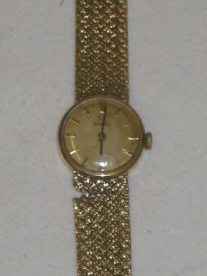 Appraisal: A CT GOLD OMEGA LADY'S WATCH the circular dial with