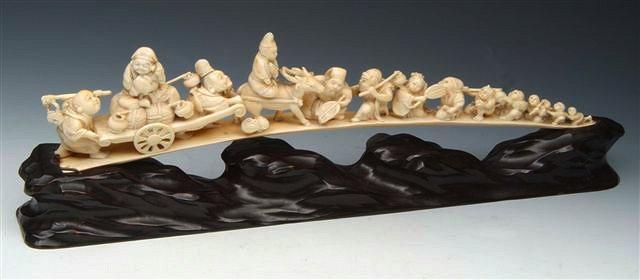 Appraisal: A JAPANESE CARVED IVORY TUSK in the form of thirteen