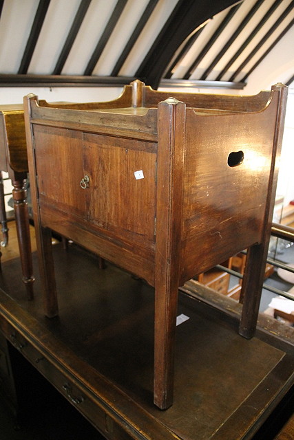 Appraisal: A GEORGE III MAHOGANY COMMODE with chamfered supports cm across